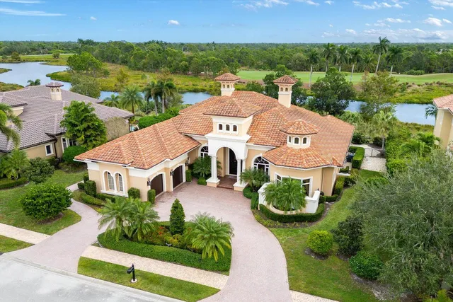 a living room with furniture a chandelier and a fireplace