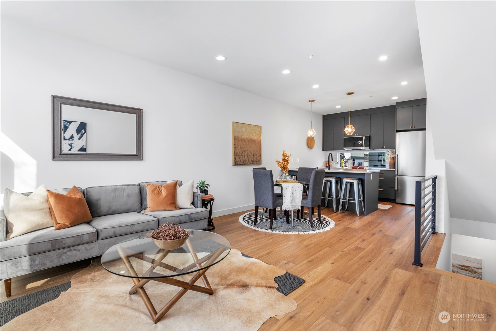 6014 B California Avenue Southwest Seattle, WA 98136 - Photo 11 of 27 a living room with furniture kitchen view and a wooden floor