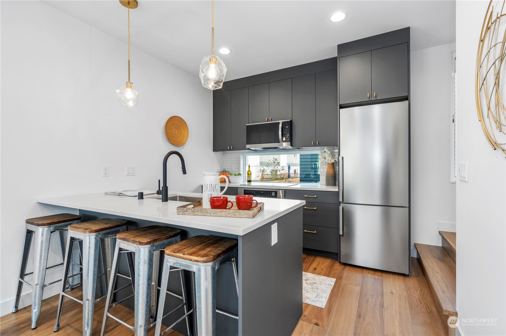 6014 B California Avenue Southwest Seattle, WA 98136 - Photo 13 of 27 a kitchen with a sink a refrigerator and a stove