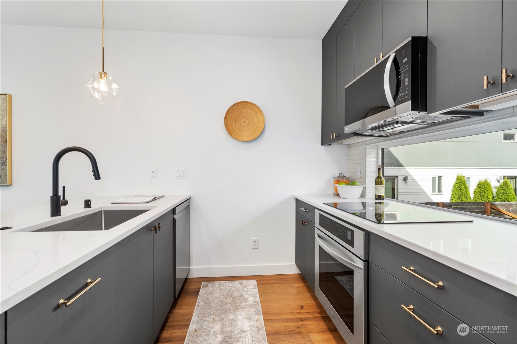6014 B California Avenue Southwest Seattle, WA 98136 - Photo 15 of 27 a kitchen with a sink and a stove