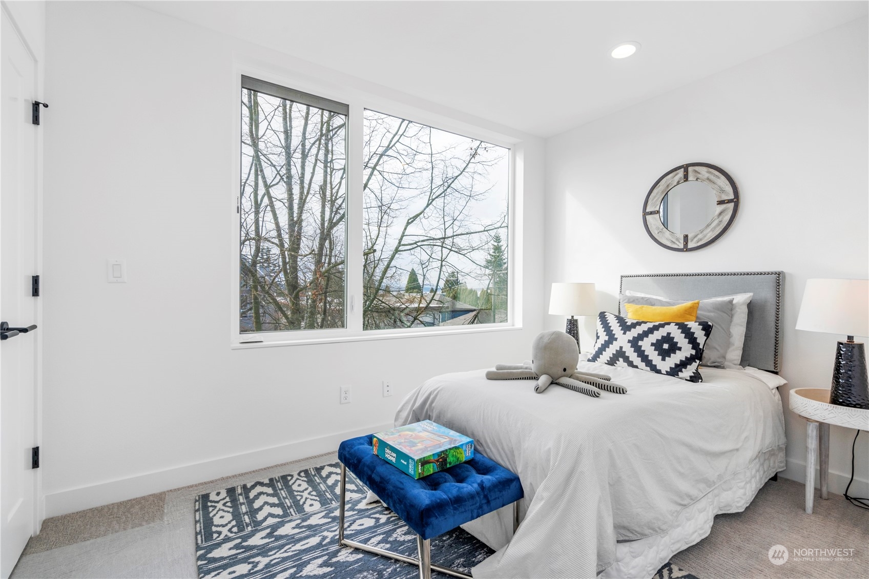 6014 B California Avenue Southwest Seattle, WA 98136 - Photo 17 of 27 a bedroom with a bed and a window