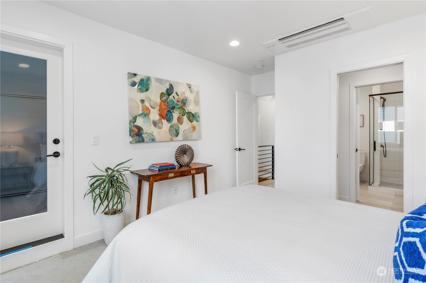 6014 B California Avenue Southwest Seattle, WA 98136 - Photo 20 of 27 a bedroom with a bed and a painting on the wall