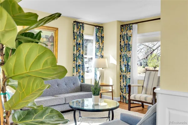 a dining room with furniture a chandelier and window