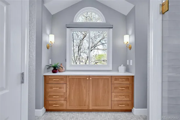 a bathroom with a sink a vanity and mirror