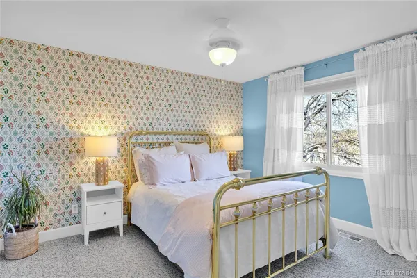 a bedroom with a bed and a lamp