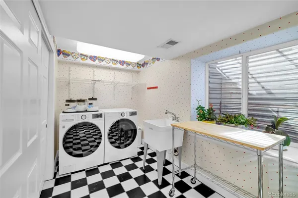 a room with a black white checkered floor and a refrigerator