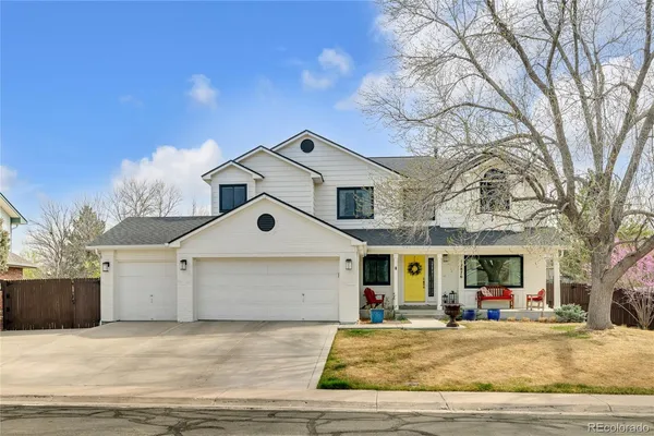a front view of a house with a garden and fire pit