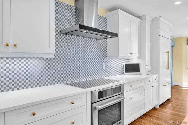 a kitchen with a sink cabinets and wooden floor