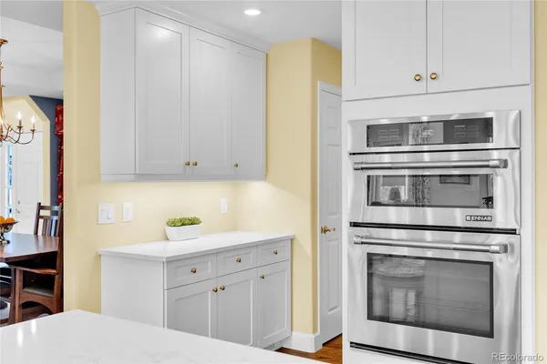 a kitchen with stainless steel appliances white cabinets and a stove