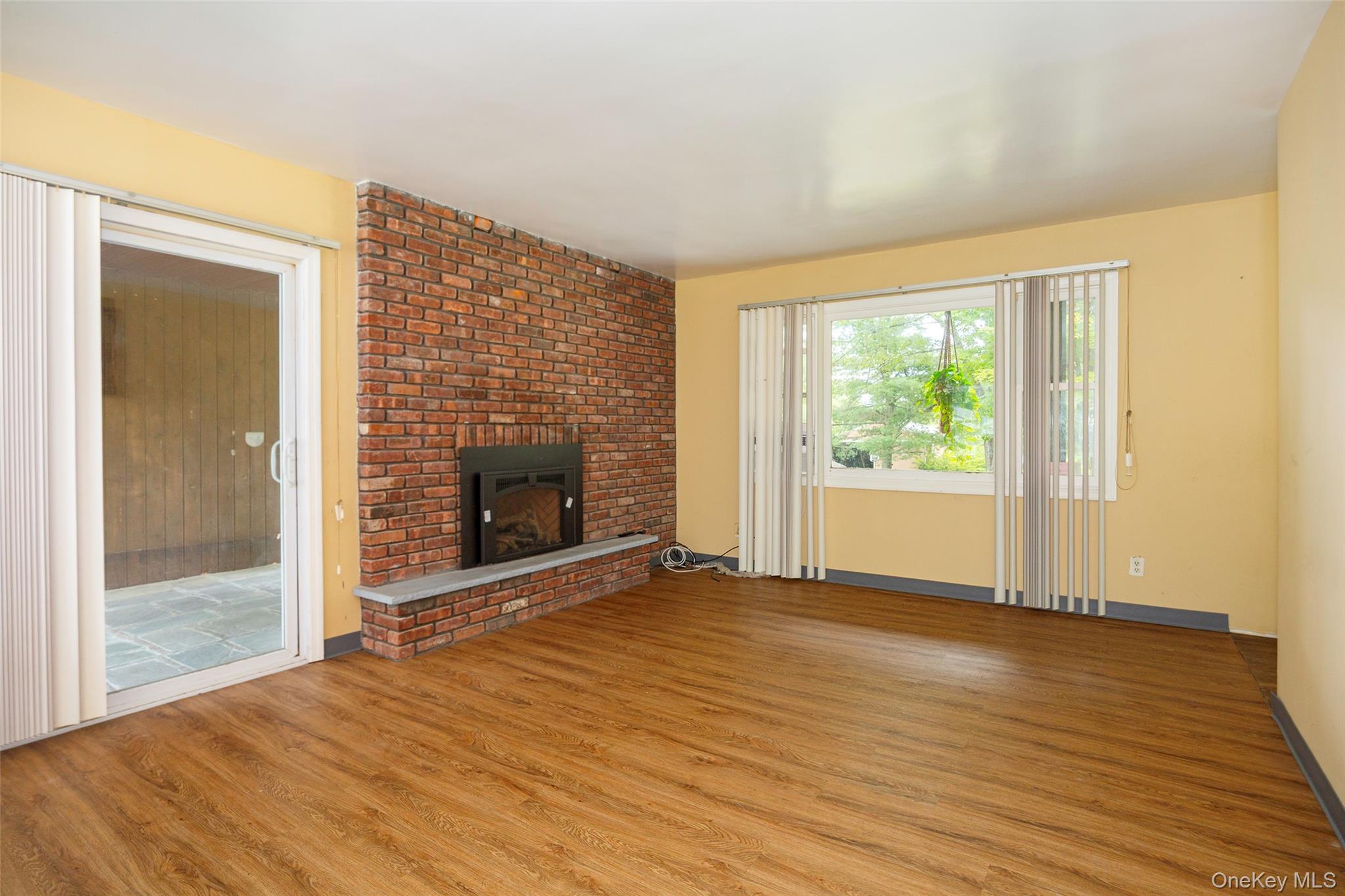 993 Highway 32 Wallkill, NY 12589 - Photo 26 of 35 Unfurnished living room with light wood-style floors and a fireplace