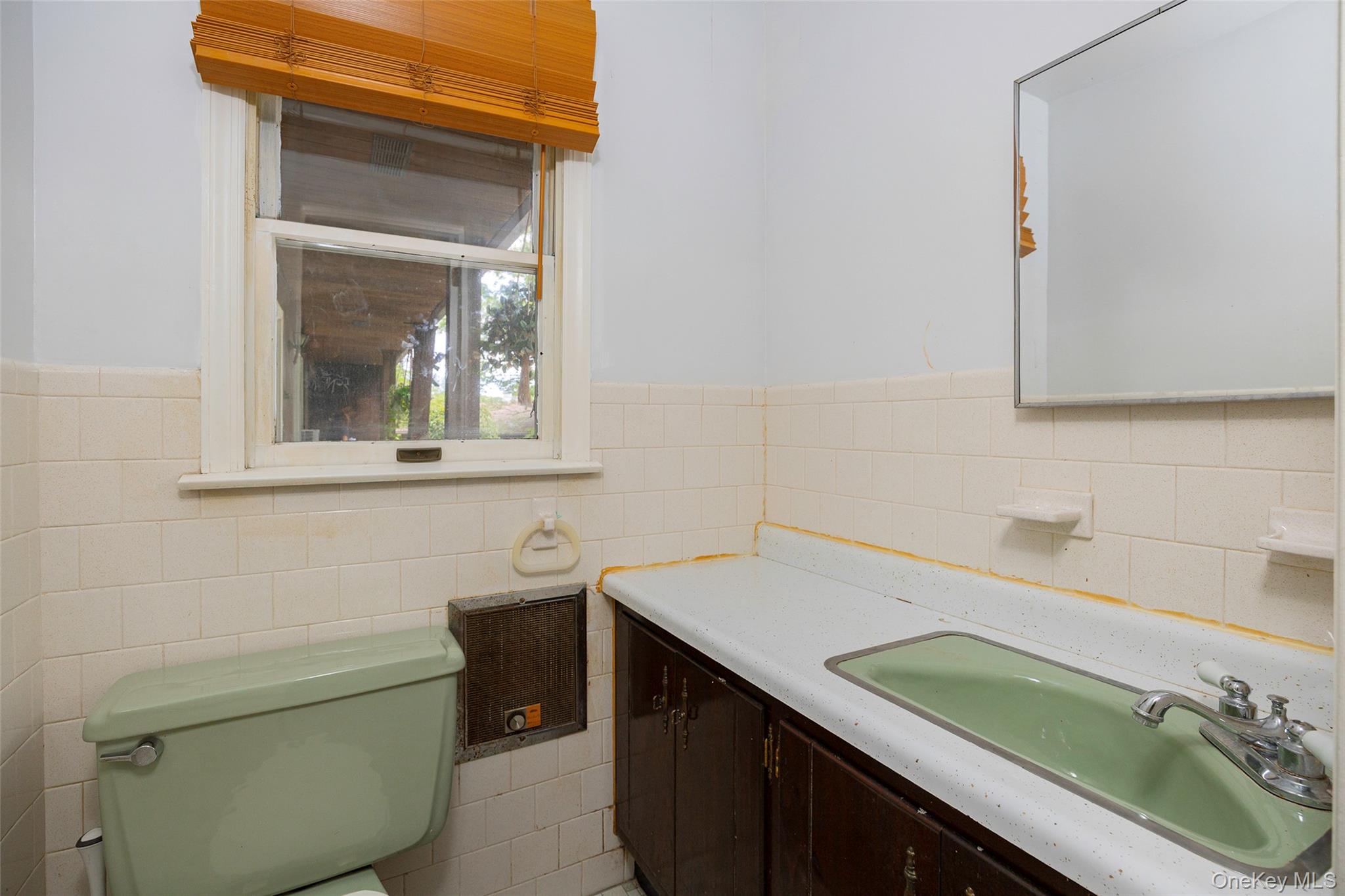 993 Highway 32 Wallkill, NY 12589 - Photo 29 of 35 Half bath featuring vanity, tile walls, and a wainscoted wall