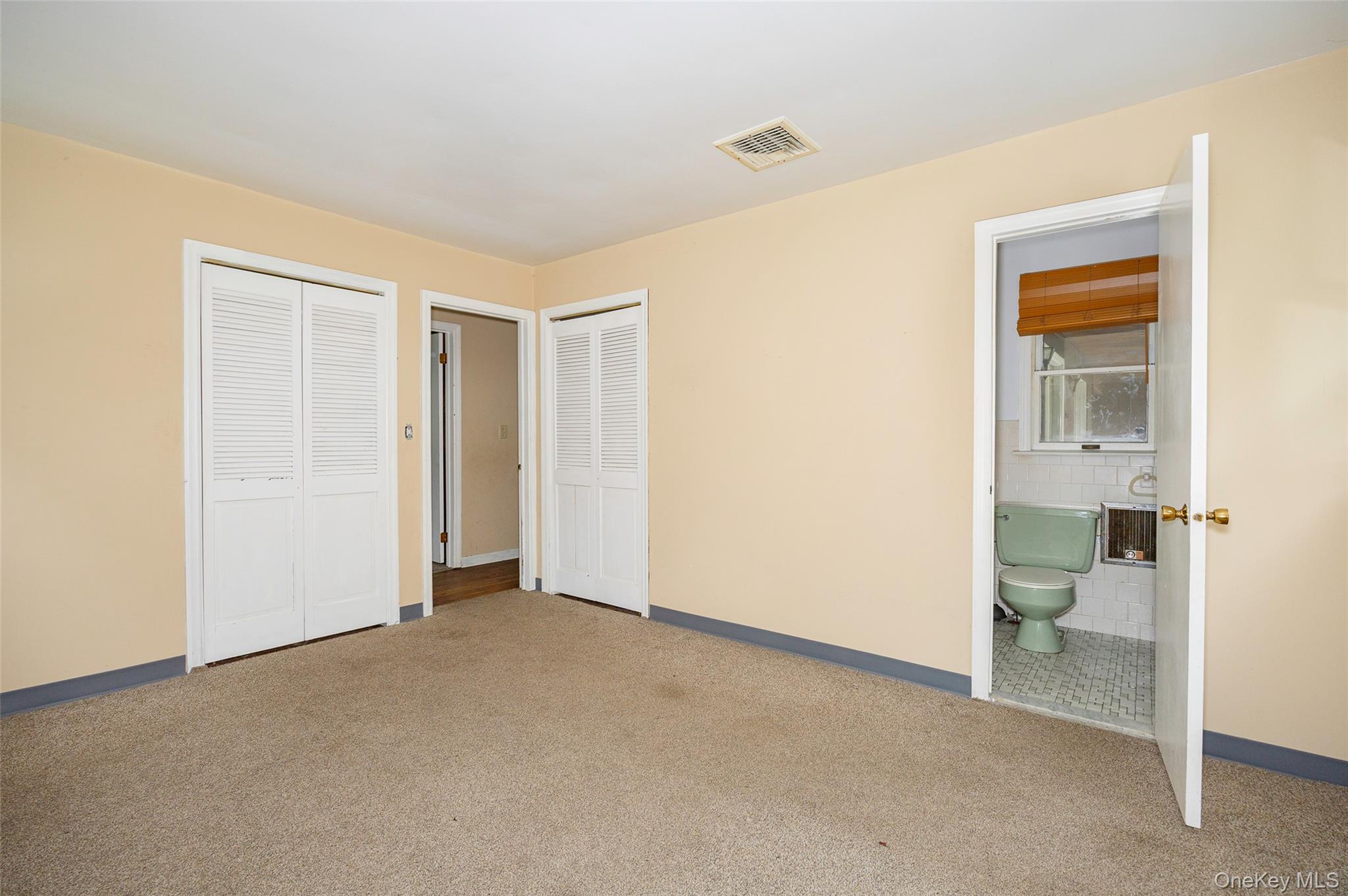 993 Highway 32 Wallkill, NY 12589 - Photo 32 of 35 Unfurnished bedroom featuring carpet flooring, multiple closets, and connected bathroom