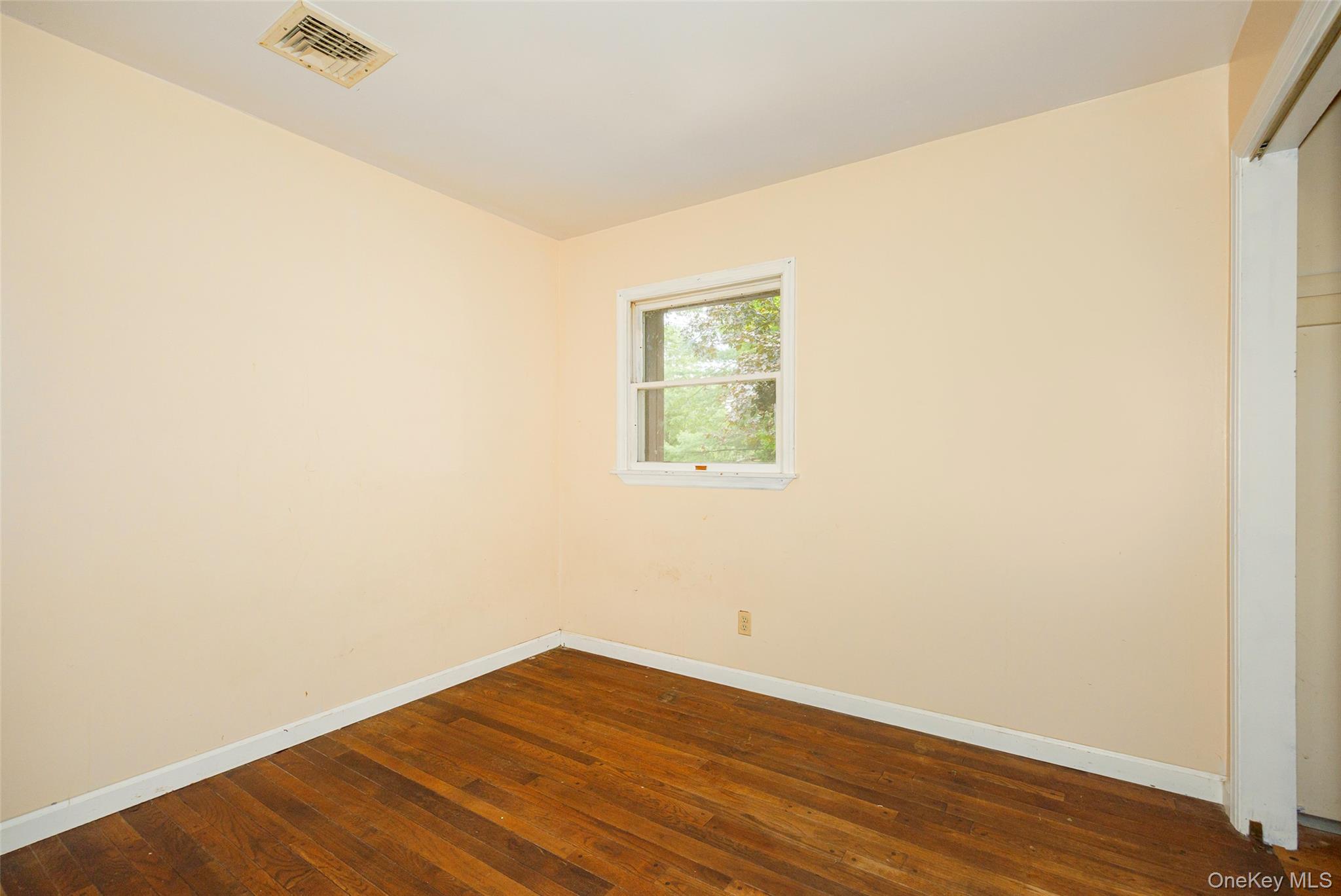 993 Highway 32 Wallkill, NY 12589 - Photo 33 of 35 Empty room with dark wood finished floors and baseboards