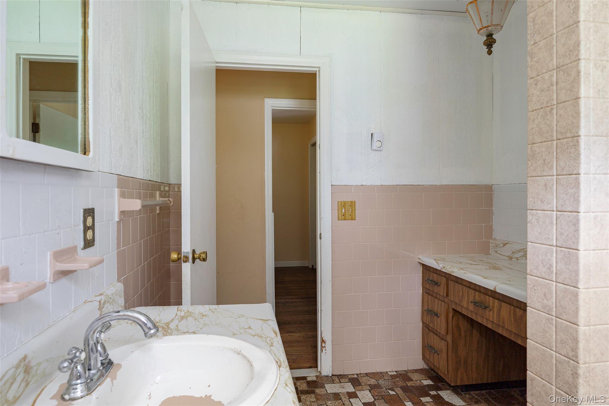 993 Highway 32 Wallkill, NY 12589 - Photo 35 of 35 Bathroom featuring tile walls, vanity, and wainscoting