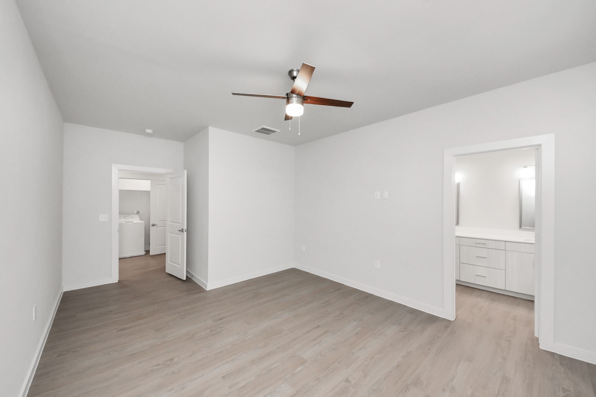 7306 Corey Rushing Lane Richmond, TX 77407 - Photo 22 of 49 Spacious Owner’s retreat with wood-like floors, walk-in closet and spa-like bath w/dual sinks.