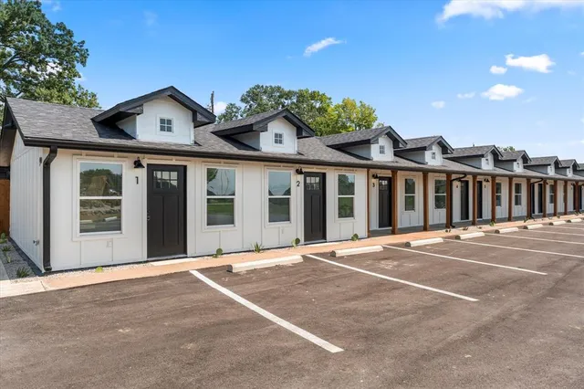 a front view of a building with a garden