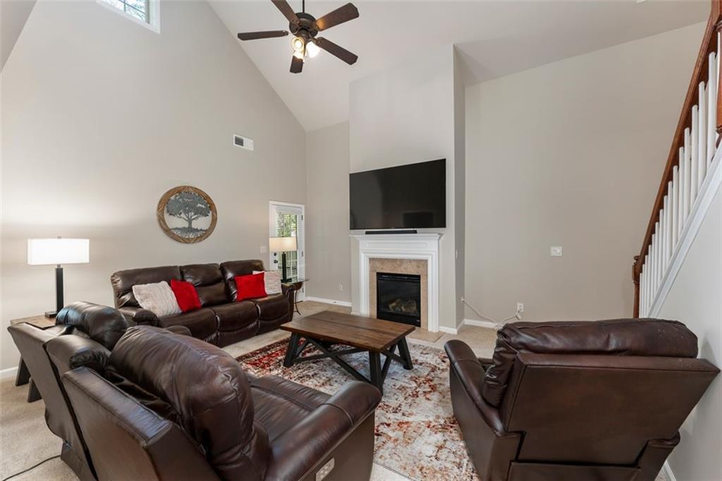113 Tyson Woods Road Acworth, GA 30102 - Photo 8 of 37 a living room with furniture a flat screen tv and a fireplace