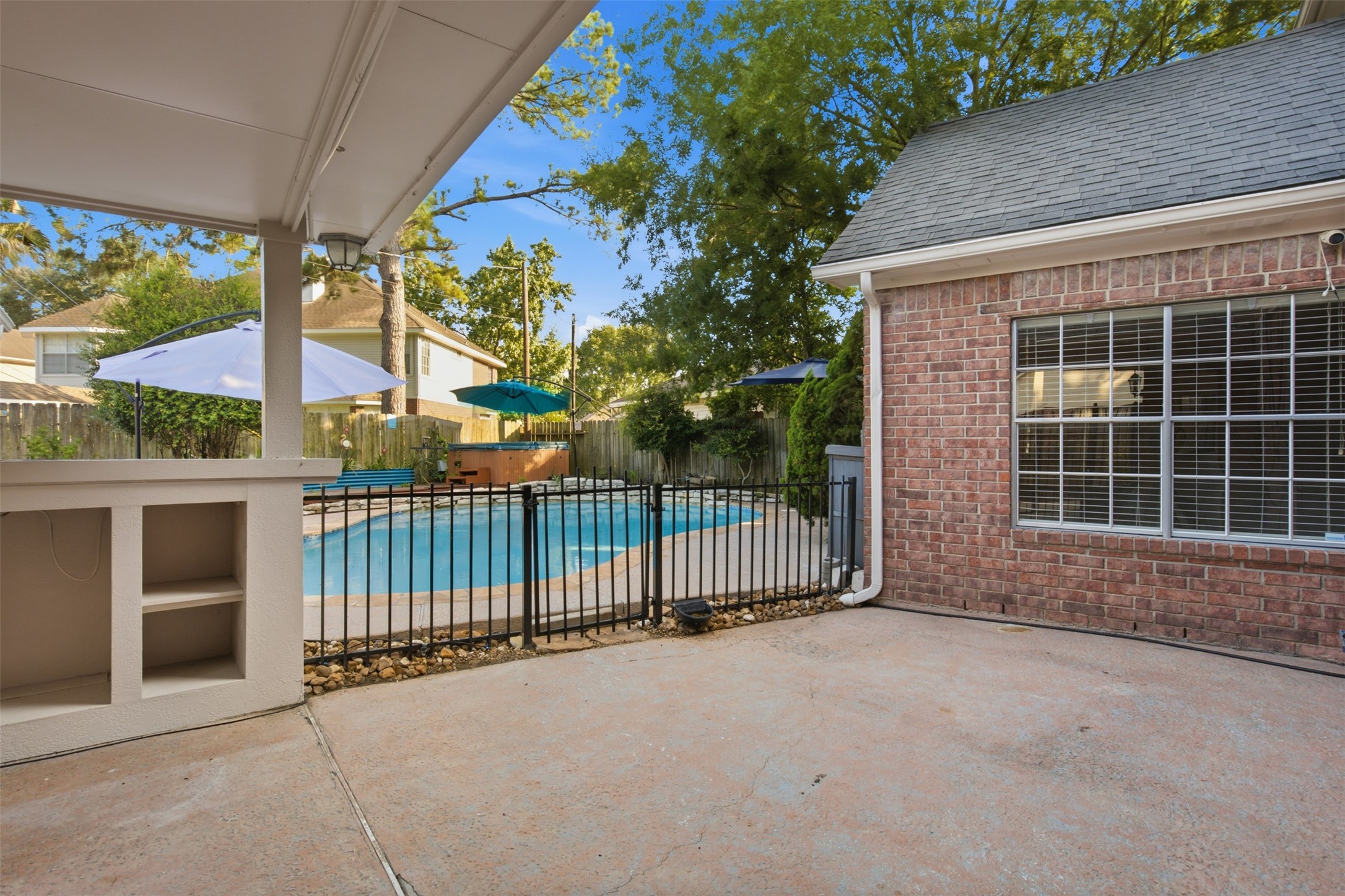 323 Magic Oaks Court Spring, TX 77388 - Photo 43 of 49 The gorgeous pool is seen here with a safety gate. This patio space is ready for entertaining!