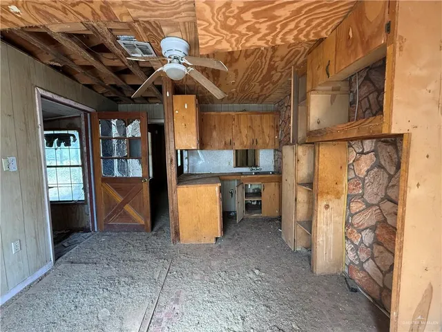 a view of a livingroom with a ceiling fan and window