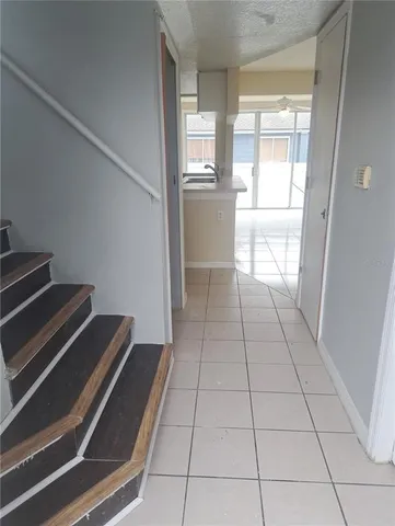 a view of kitchen with furniture and electronic appliances