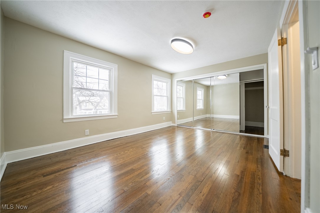 3816 Summit Park Road Cleveland Heights, OH 44121 - Photo 15 of 35 Unfurnished bedroom featuring dark wood-style flooring and a closet
