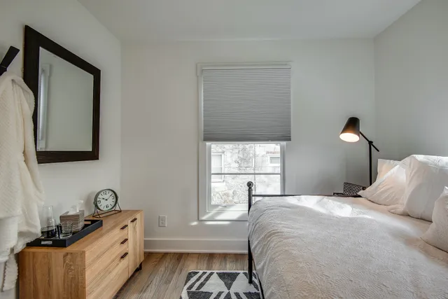 a bedroom with a bed and a window