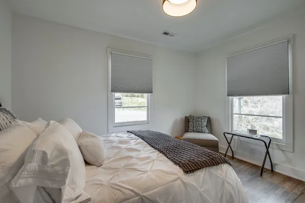 a bedroom with a bed and a window