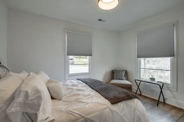 a bedroom with a bed and a window