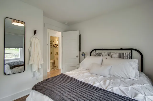 a bedroom with a bed and a mirror