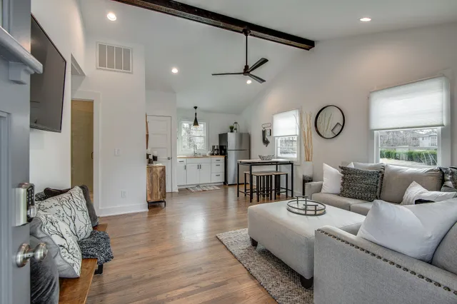 a living room with furniture and a clock