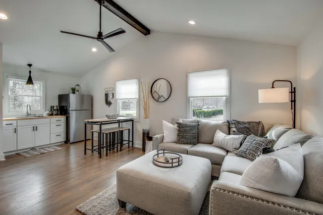 a living room with furniture and wooden floor