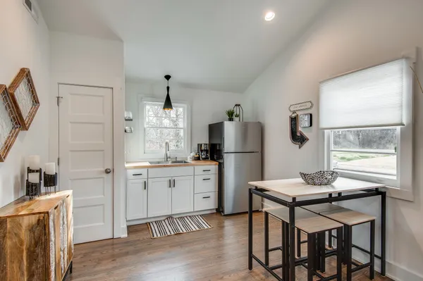 a kitchen with refrigerator cabinets and wooden floor
