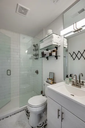 a bathroom with a sink toilet and shower