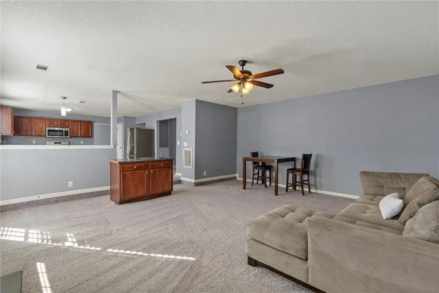a view of an empty room with a ceiling fan