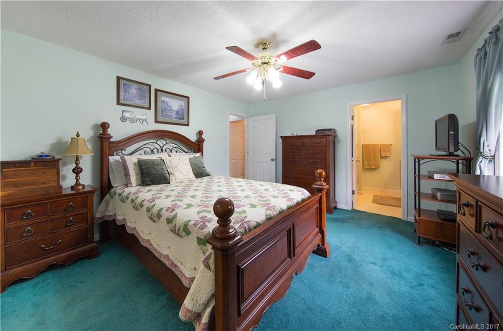 1610 Deer Run Road Catawba, SC 29704 - Photo 13 of 23 a bedroom with a bed and a chandelier