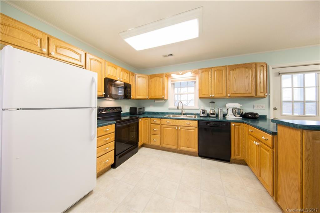 1610 Deer Run Road Catawba, SC 29704 - Photo 3 of 23 a kitchen with granite countertop stainless steel appliances a refrigerator sink and cabinets