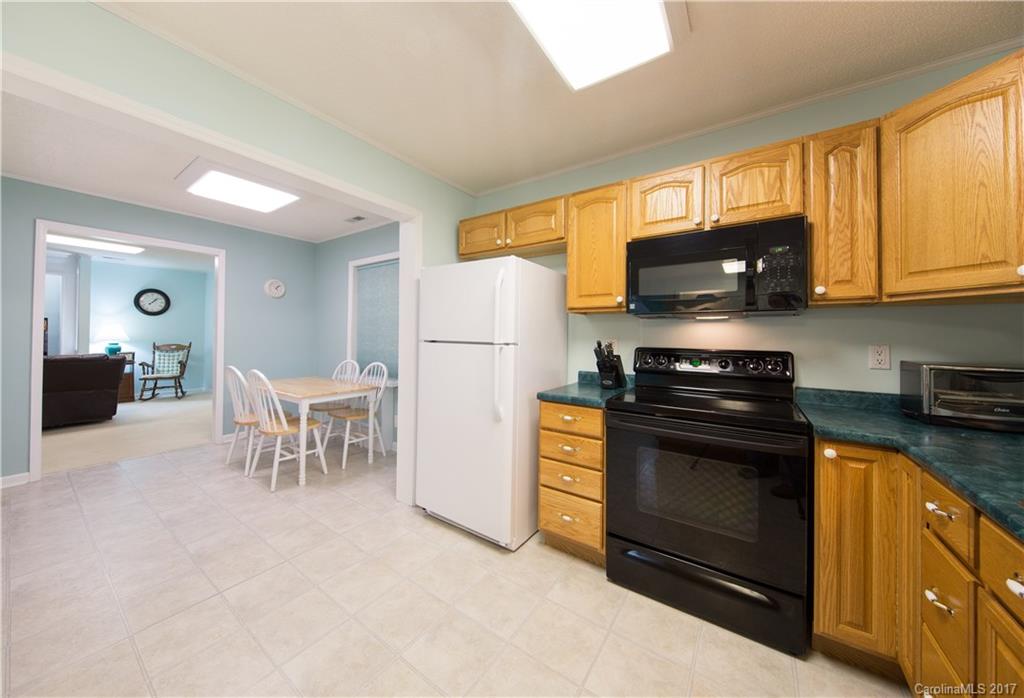 1610 Deer Run Road Catawba, SC 29704 - Photo 5 of 23 a kitchen with granite countertop a refrigerator stove and microwave