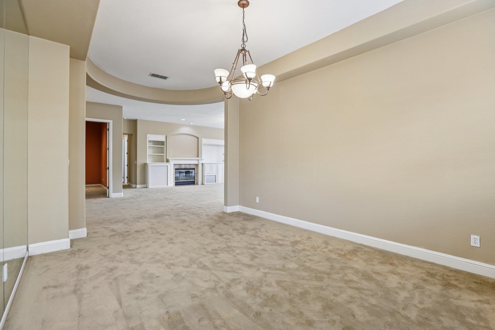 5227 Ramsdell Court Antioch, CA 94531 - Photo 14 of 58 Carpeted spare room with a tiled fireplace and a chandelier