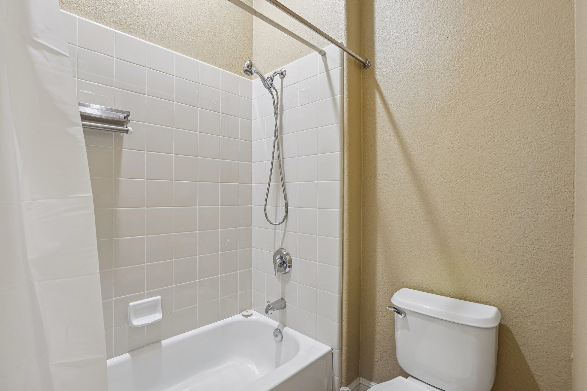 5227 Ramsdell Court Antioch, CA 94531 - Photo 26 of 58 Bathroom with a textured wall and bathing tub / shower combination
