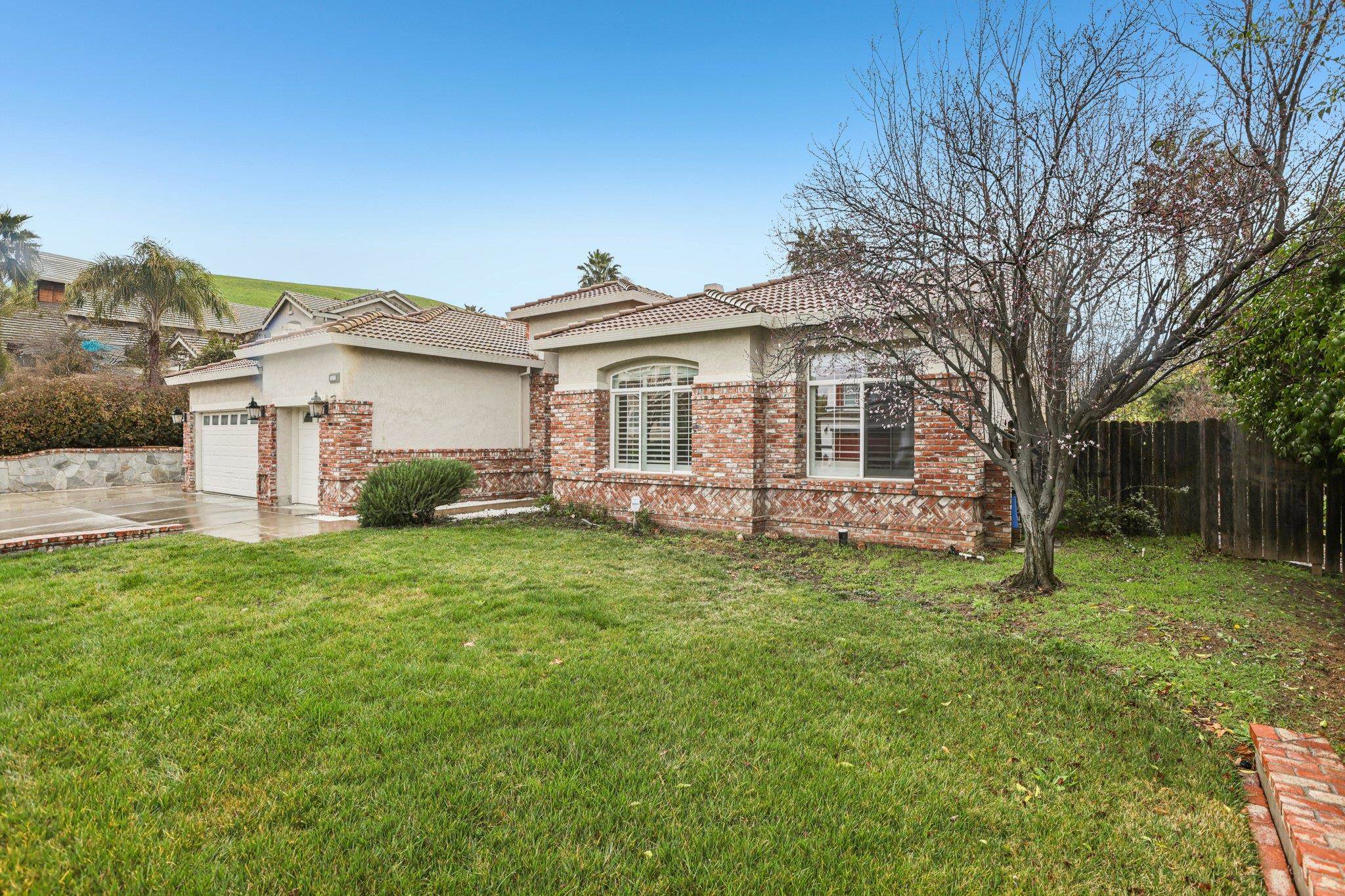 5227 Ramsdell Court Antioch, CA 94531 - Photo 3 of 58 View of front of house featuring stucco siding, brick siding, a tiled roof, driveway, and a patio