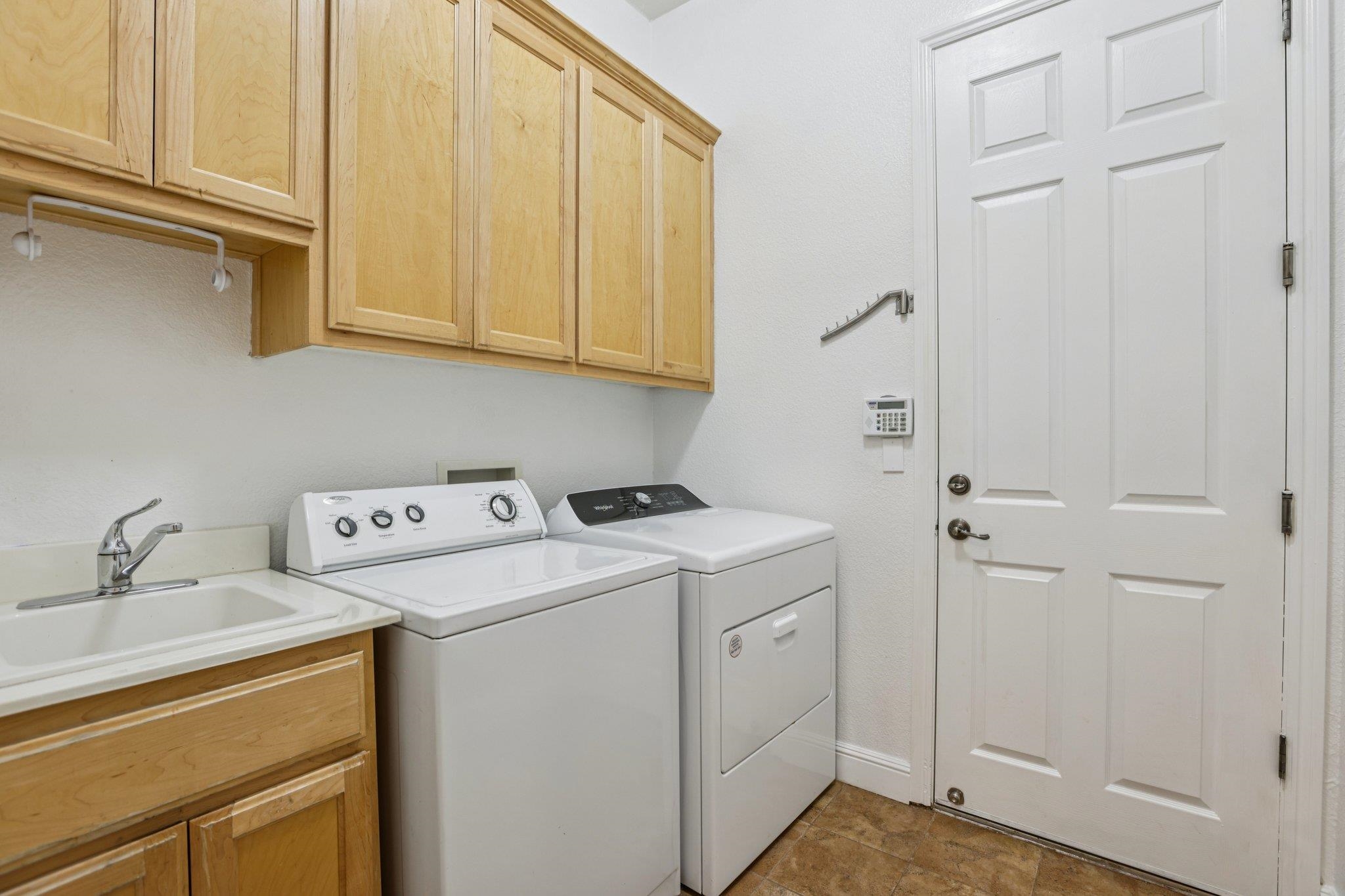 5227 Ramsdell Court Antioch, CA 94531 - Photo 33 of 58 Laundry area featuring cabinet space and separate washer and dryer