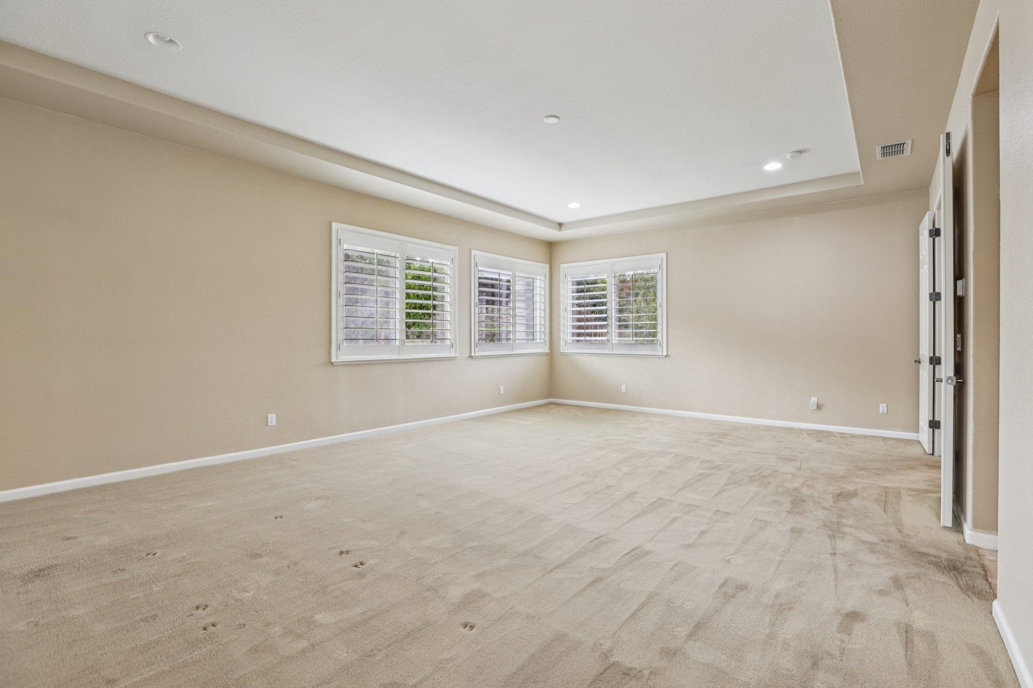 5227 Ramsdell Court Antioch, CA 94531 - Photo 38 of 58 Empty room with light carpet, a tray ceiling, and recessed lighting