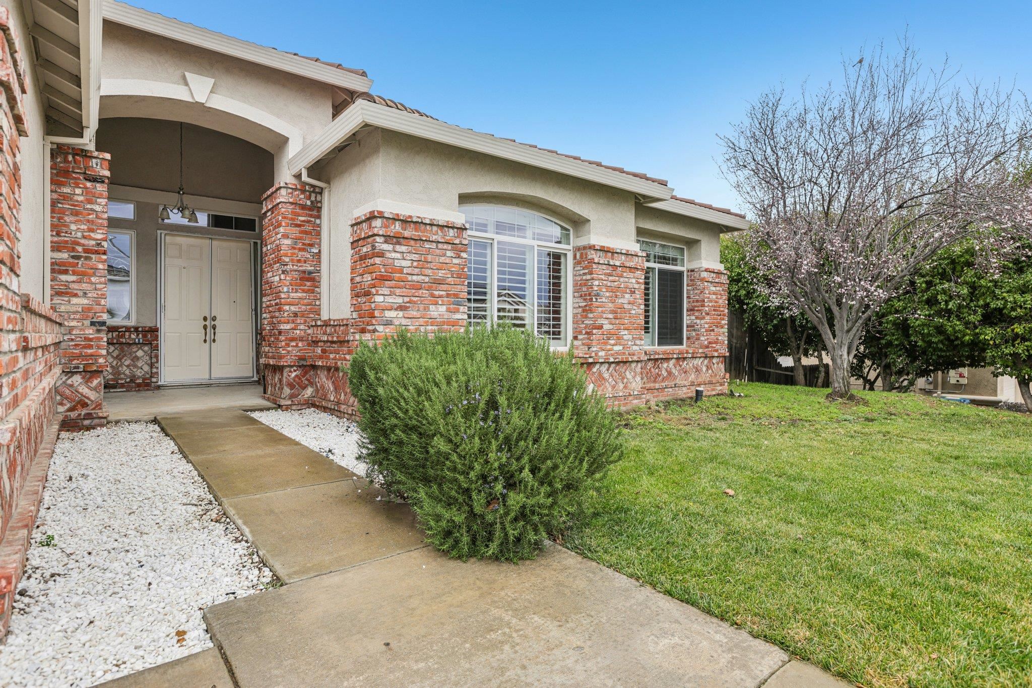 5227 Ramsdell Court Antioch, CA 94531 - Photo 4 of 58 Property entrance with stucco siding, a yard, and brick siding
