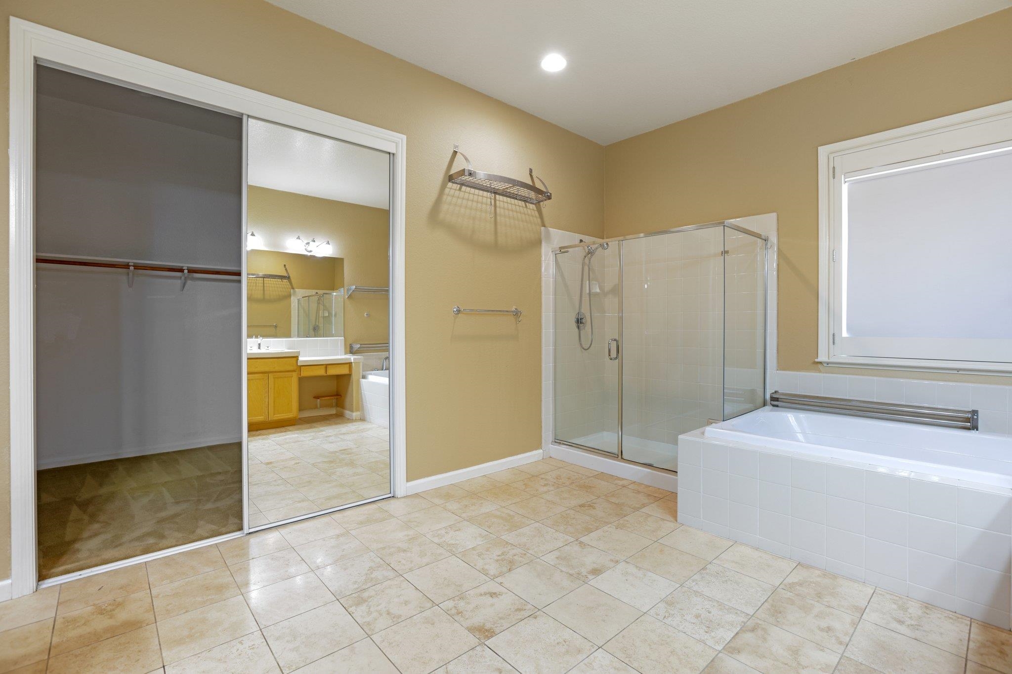 5227 Ramsdell Court Antioch, CA 94531 - Photo 40 of 58 Full bathroom with a garden tub, a spacious closet, a stall shower, vanity, and light tile patterned floors