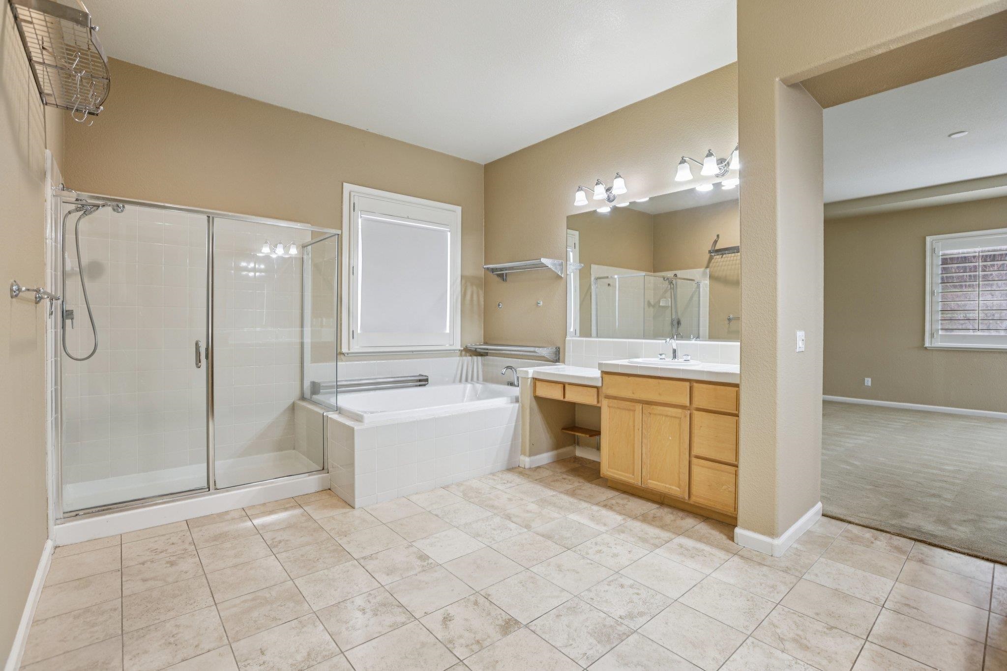 5227 Ramsdell Court Antioch, CA 94531 - Photo 42 of 58 Bathroom featuring a garden tub, a stall shower, vanity, and light carpet
