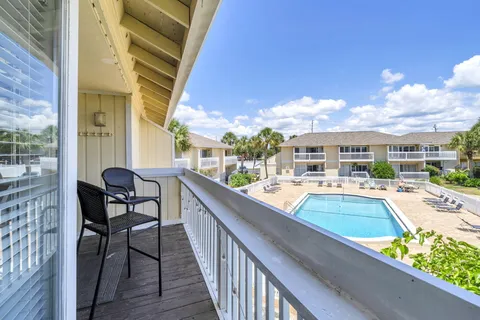 a view of swimming pool from a balcony