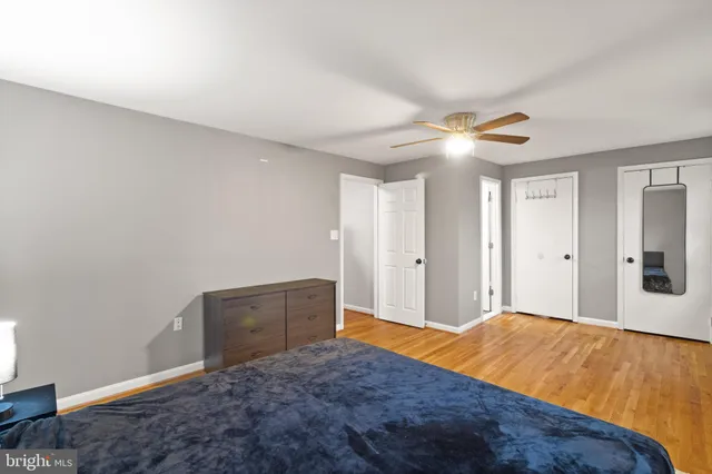 a bedroom with a bed and a ceiling fan