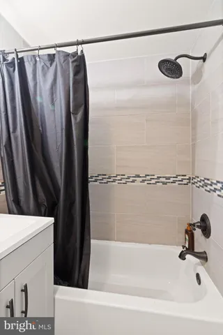 a bathroom with a bathtub and a shower
