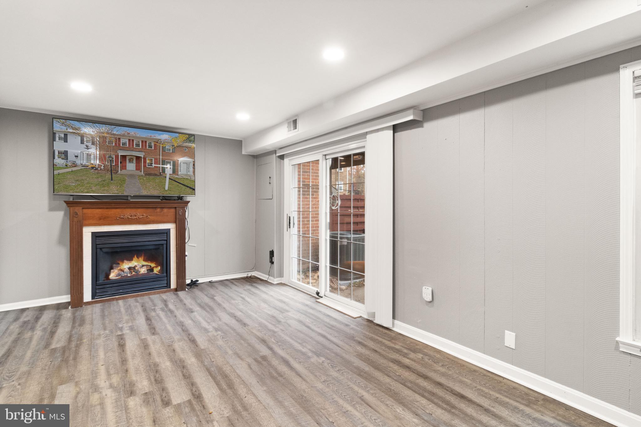 1315 Mead Terrace Woodbridge, VA 22191 - Photo 20 of 32 an empty room with wooden floor a fireplace and windows