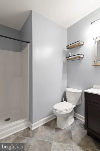 a bathroom with a toilet and a shower